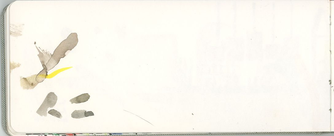 a mostly blank page of the same watercolor journal with a few test swatches from color mixing.